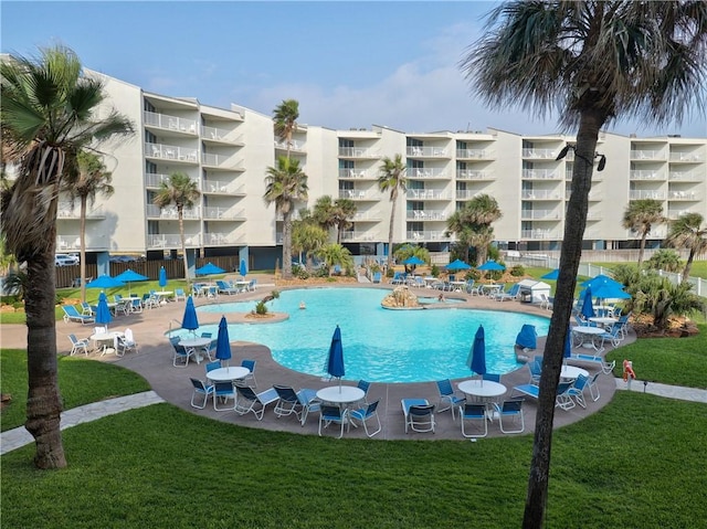 800 Sandcastle Dr Unit 129, Port Aransas, TX 78373 - community pool with a lawn