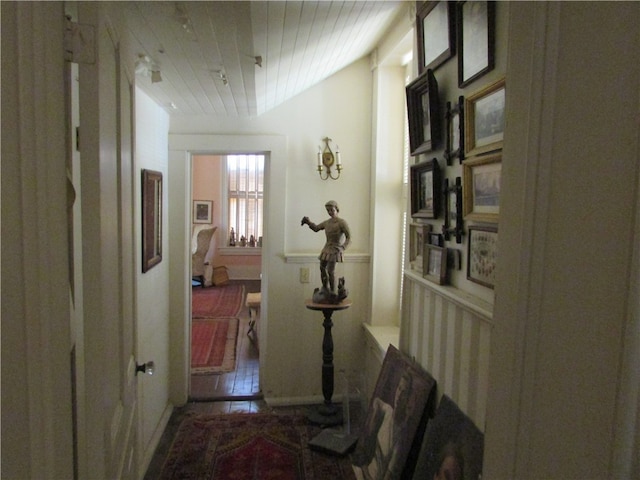 hallway featuring vaulted ceiling