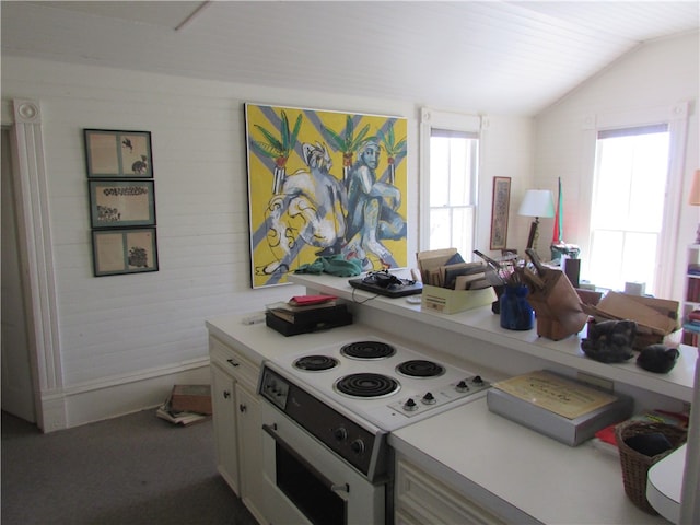 kitchen featuring white electric range, carpet flooring, and lofted ceiling