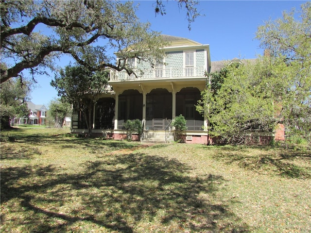 exterior space with a lawn and a sunroom