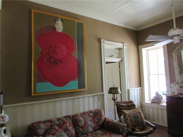 living room featuring ceiling fan and ornamental molding