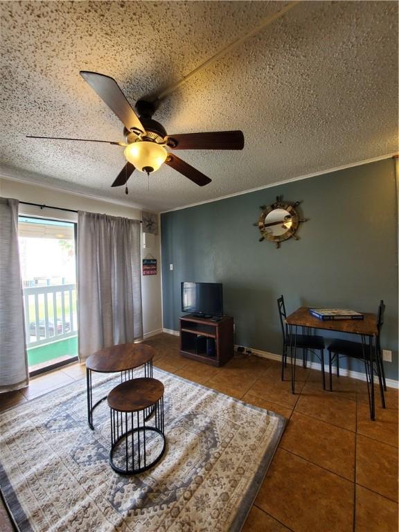 3938 Surfside Blvd Unit 1121, Corpus Christi, TX 78402 - tiled living room featuring ceiling fan and a textured ceiling