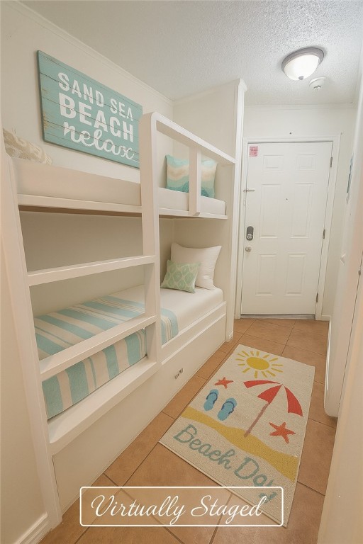 3938 Surfside Blvd Unit 1121, Corpus Christi, TX 78402 - bedroom featuring tile patterned flooring and a textured ceiling