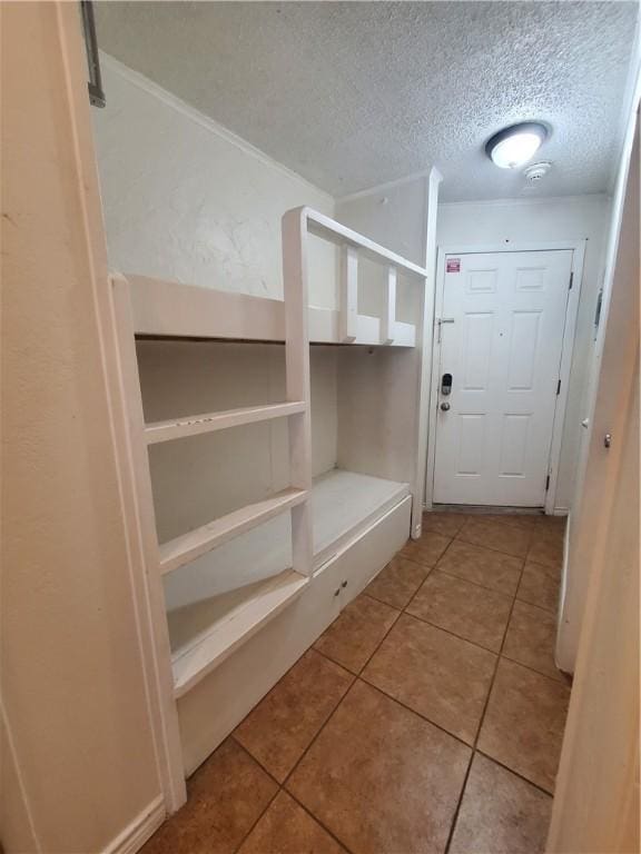 3938 Surfside Blvd Unit 1121, Corpus Christi, TX 78402 - mudroom featuring a textured ceiling and tile patterned floors