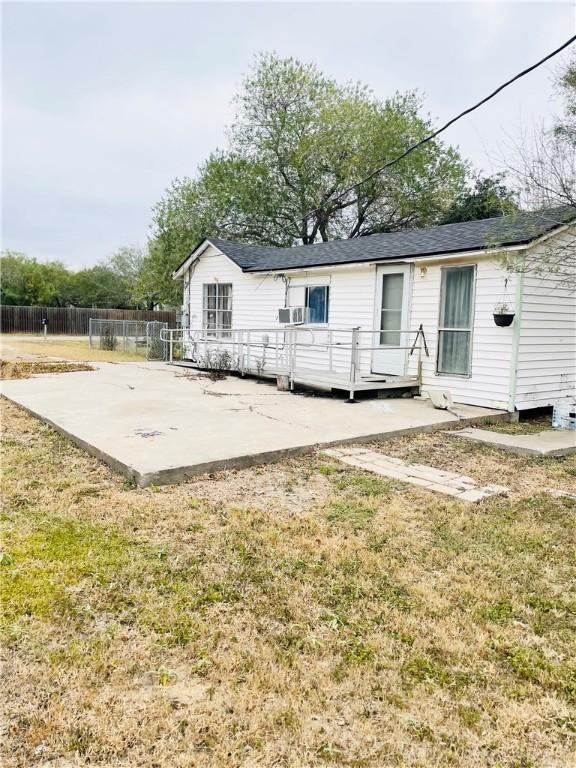 back of property with a yard, a patio, cooling unit, and a wooden deck