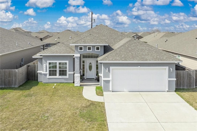 view of front of property featuring a front lawn and a garage