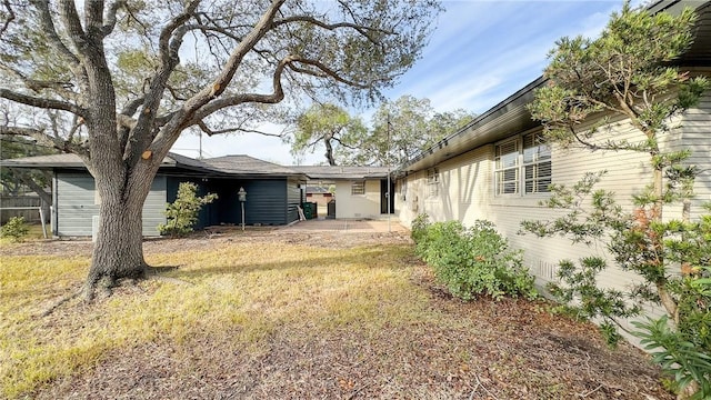 view of home's exterior with a yard and a patio