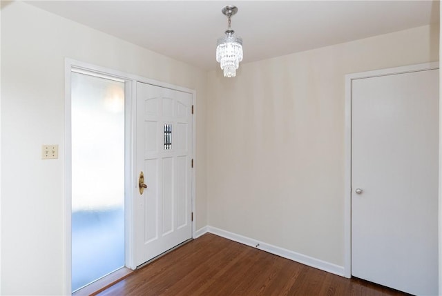 foyer featuring dark hardwood / wood-style flooring and a notable chandelier