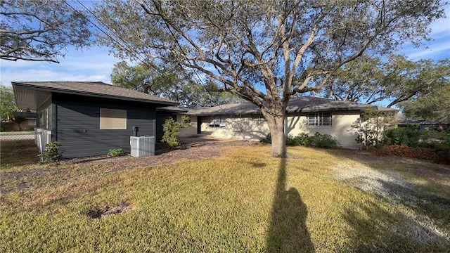 exterior space featuring a lawn and cooling unit