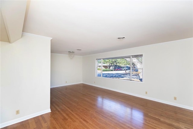 unfurnished room featuring ornamental molding and hardwood / wood-style floors