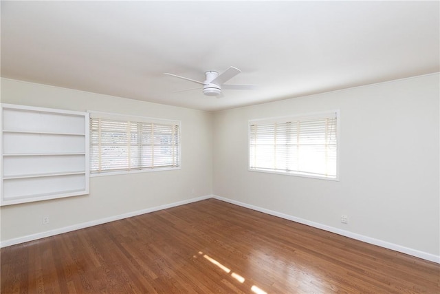 empty room with ceiling fan, built in features, and hardwood / wood-style floors