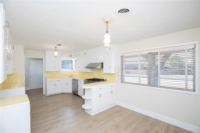 kitchen with light hardwood / wood-style floors, dishwasher, white cabinetry, and pendant lighting