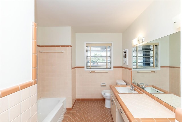 bathroom with a tub, tile walls, toilet, and tile patterned flooring