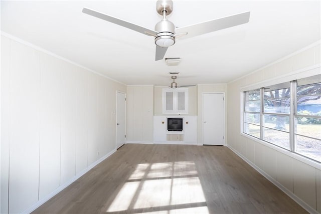 unfurnished living room with ceiling fan, ornamental molding, and hardwood / wood-style floors