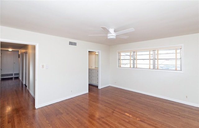 spare room with ceiling fan and dark hardwood / wood-style floors