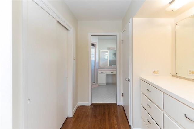 hallway with dark hardwood / wood-style flooring