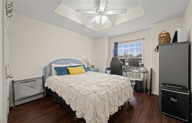 bedroom featuring a raised ceiling, ceiling fan, and dark hardwood / wood-style floors