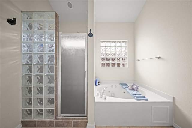 bathroom featuring separate shower and tub