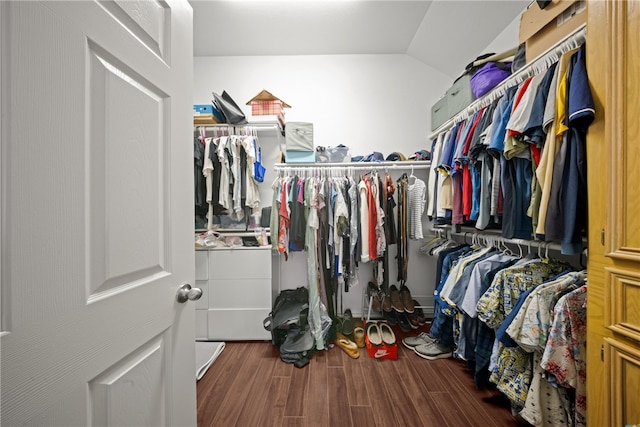 walk in closet featuring dark hardwood / wood-style flooring and lofted ceiling