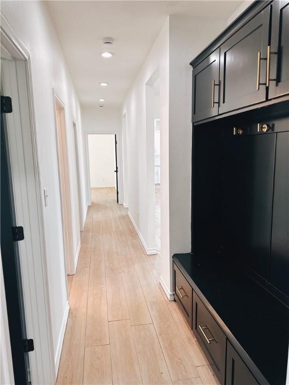 mudroom with light wood-style flooring and baseboards