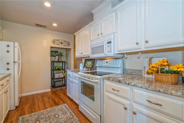 kitchen featuring dark wood-type flooring, white appliances, white cabinetry, and light stone countertops