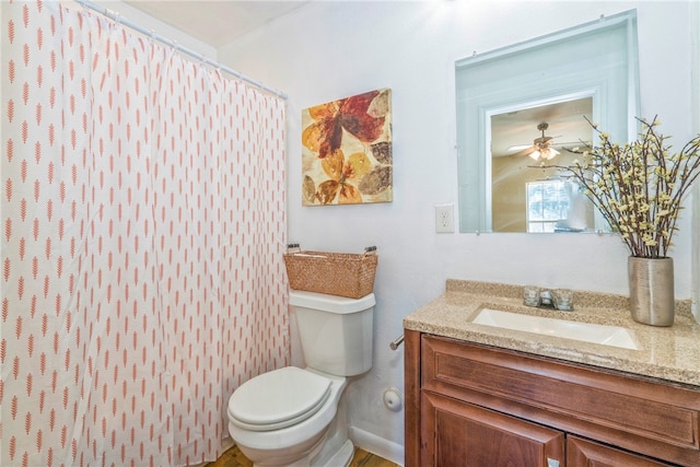 bathroom featuring vanity, ceiling fan, toilet, and a shower with shower curtain