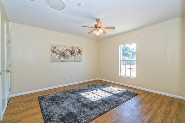 spare room featuring dark hardwood / wood-style flooring and ceiling fan