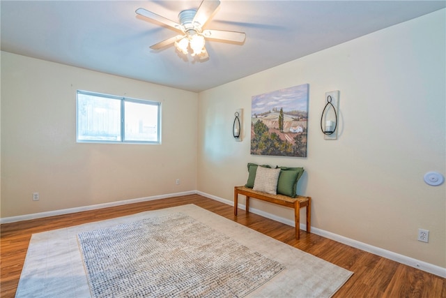 sitting room with hardwood / wood-style flooring and ceiling fan