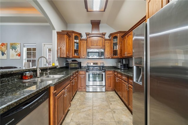 kitchen with light tile patterned flooring, sink, crown molding, dark stone countertops, and stainless steel appliances