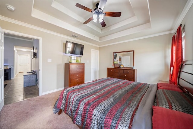 bedroom featuring ceiling fan, ornamental molding, carpet flooring, and a raised ceiling