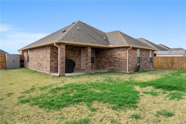 back of house featuring a yard and a patio