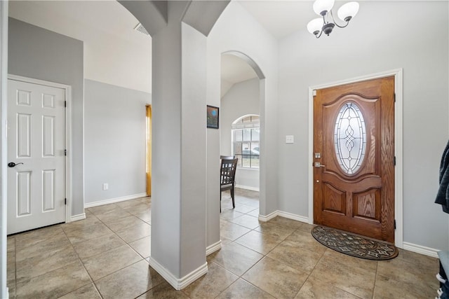 tiled foyer entrance with lofted ceiling