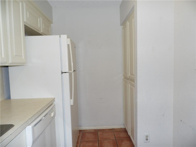 13656 Teague Ln Unit 33, Corpus Christi, TX 78410 - kitchen featuring light countertops, tile patterned flooring, freestanding refrigerator, and baseboards
