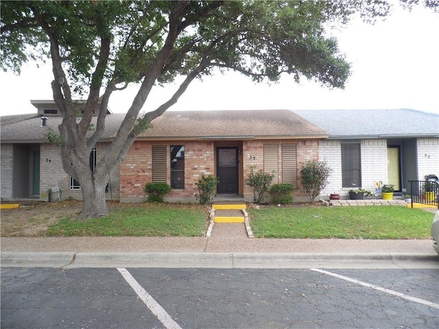 13656 Teague Ln Unit 33, Corpus Christi, TX 78410 - ranch-style house with brick siding, uncovered parking, and a front yard