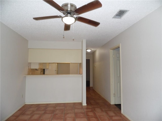 13656 Teague Ln Unit 33, Corpus Christi, TX 78410 - tiled empty room featuring a textured ceiling, a ceiling fan, and baseboards