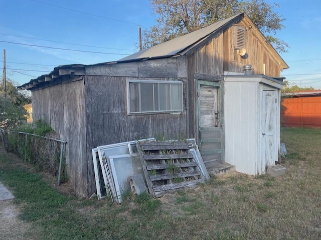 view of outbuilding with a lawn