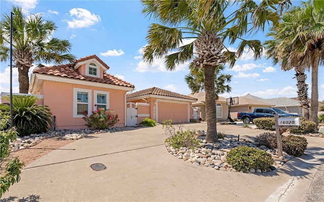 16025 Cuttysark St, Corpus Christi, TX 78418 - mediterranean / spanish home with a garage, curved driveway, a tile roof, and stucco siding