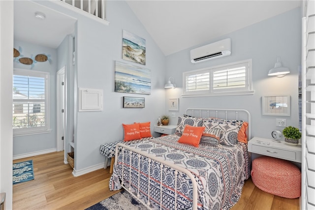 16025 Cuttysark St, Corpus Christi, TX 78418 - bedroom featuring baseboards, multiple windows, light wood finished floors, and a wall mounted air conditioner