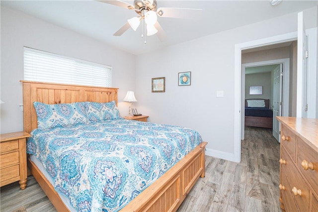 bedroom with ceiling fan and light hardwood / wood-style floors