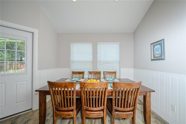 dining room featuring vaulted ceiling and hardwood / wood-style floors