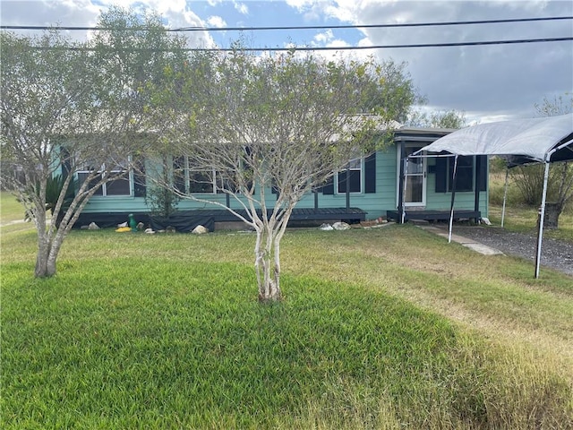 view of front facade with a front lawn and a carport