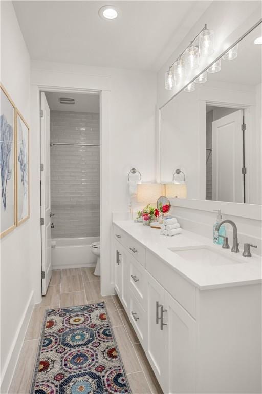 bathroom featuring shower / bathtub combination, visible vents, toilet, wood tiled floor, and vanity