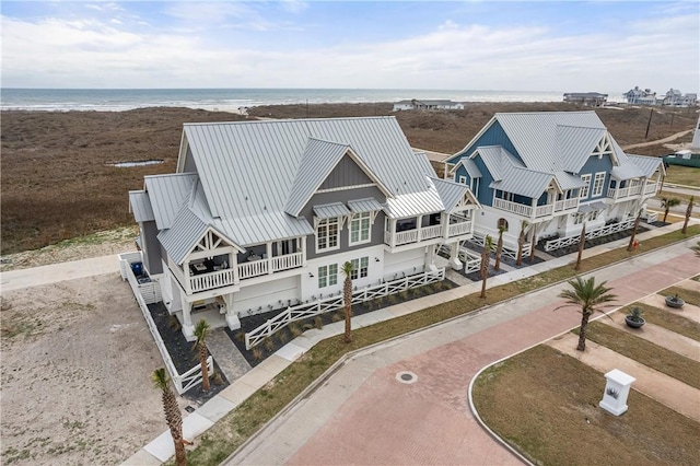 bird's eye view with a water view and a beach view