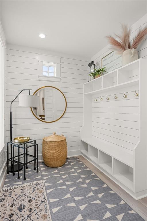 mudroom featuring recessed lighting and wooden walls