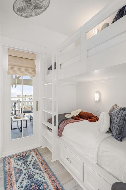 bedroom with access to exterior and light wood-style flooring