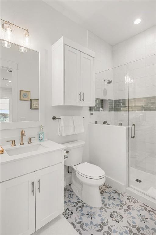 bathroom featuring tile patterned flooring, a shower stall, toilet, and vanity