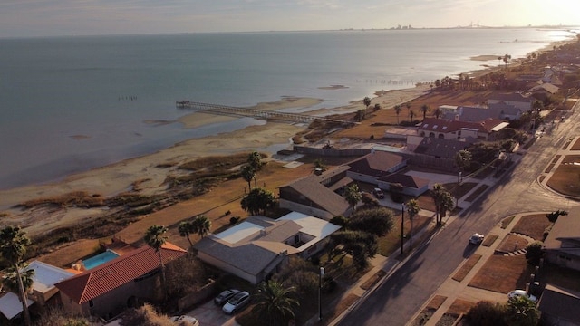 aerial view at dusk featuring a water view