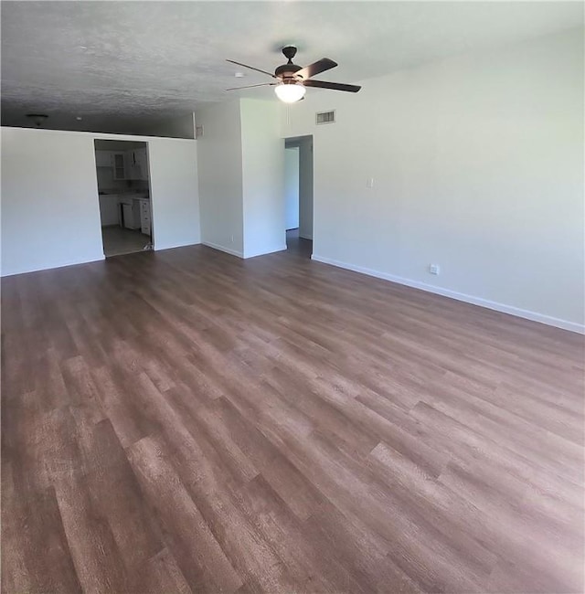 1514 E Johnston Ave, Kingsville, TX 78363 - empty room with dark wood finished floors, visible vents, baseboards, and ceiling fan