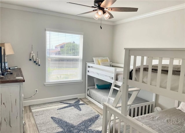  - bedroom with wood finished floors, baseboards, ornamental molding, and a ceiling fan