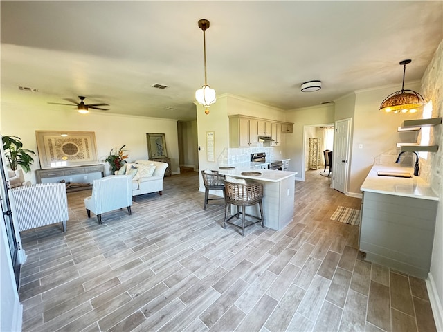 kitchen featuring kitchen peninsula, stainless steel electric stove, sink, pendant lighting, and light hardwood / wood-style floors